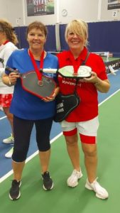 June and teammate Sheila smiling and showing off their silver medals at the Pickleball tournament